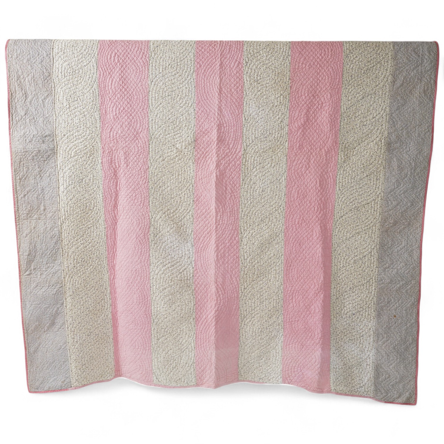 An English 19th century, highly ornate hand quilted English bedcover. Designed using alternating stripes, in a plain pink and a small printed floral cotton, then finishing with two borders of a darker minute spot floral